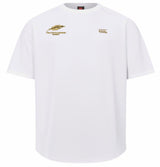 The Montgomery Yellowhammers Everest Training Tee by EMB Canterbury is a plain white, short-sleeve rugby performance shirt featuring a gold feather logo and text on the left chest, with a small gold Canterbury logo on the right chest. Perfect for your Everest Training sessions.