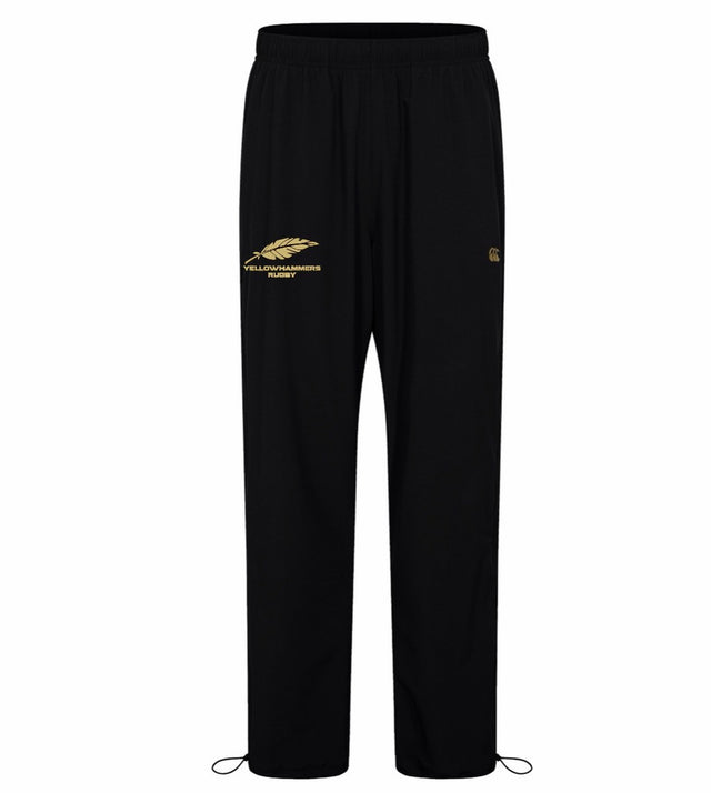 The Montgomery Yellowhammers Tempo+ 32″ Trackpant by EMB Canterbury features black athletic poly fabric, an elastic waistband, a gold feather and “Yellowhammer Rugby” logo on the left thigh, and adjustable cords at the ankles—making it the perfect choice for official Montgomery Yellowhammers track pant gear.