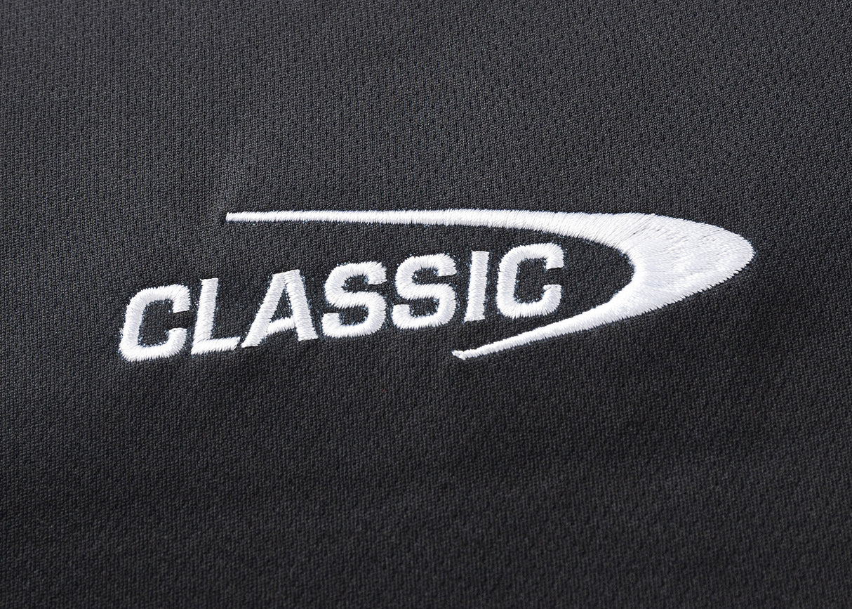 Close-up of "CLASSIC" embroidered in white with a curved underline on black, moisture-wicking fabric by Classic Sportswear—a feature of the Gallagher Chiefs Super Rugby 25/26 Team Polo.