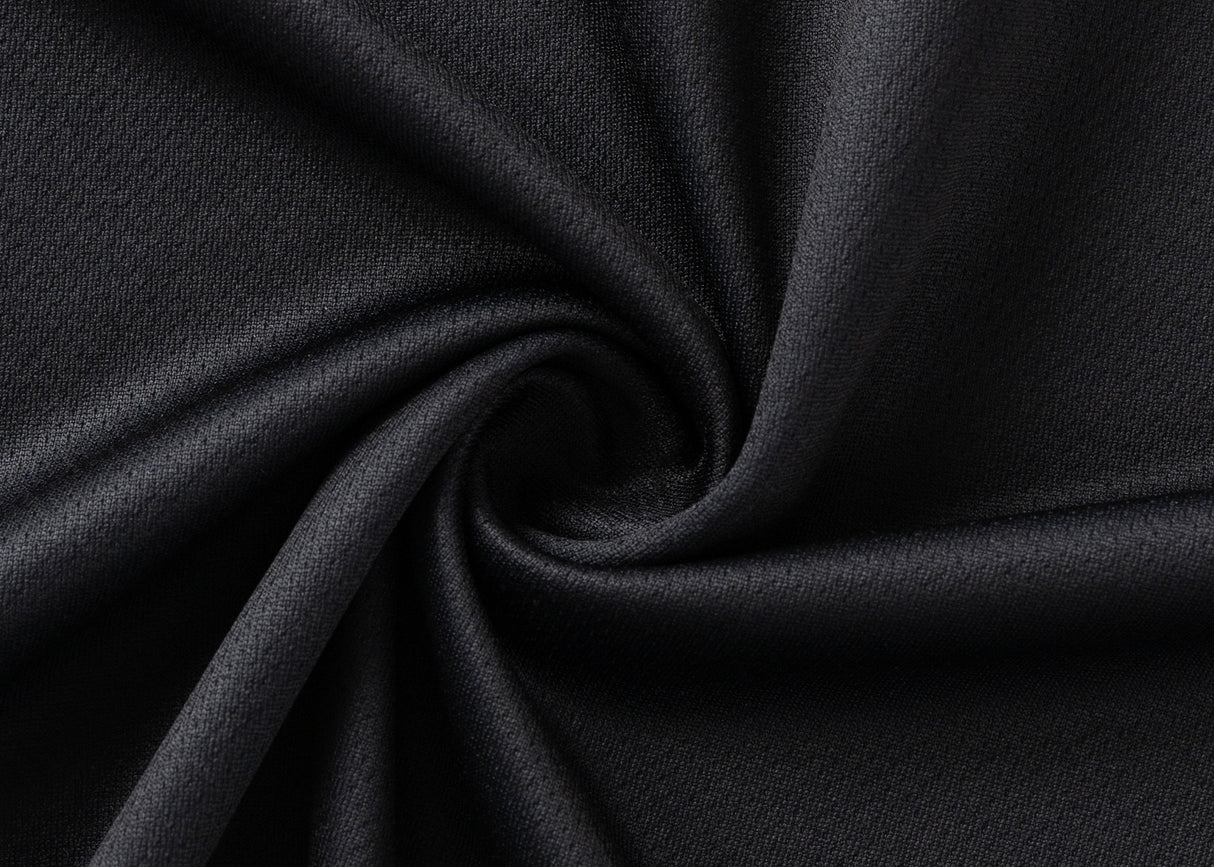 Close-up of the Gallagher Chiefs Super Rugby 25/26 Team Polo by Classic Sportswear, highlighting its black moisture-wicking fabric, texture, and smooth folds.