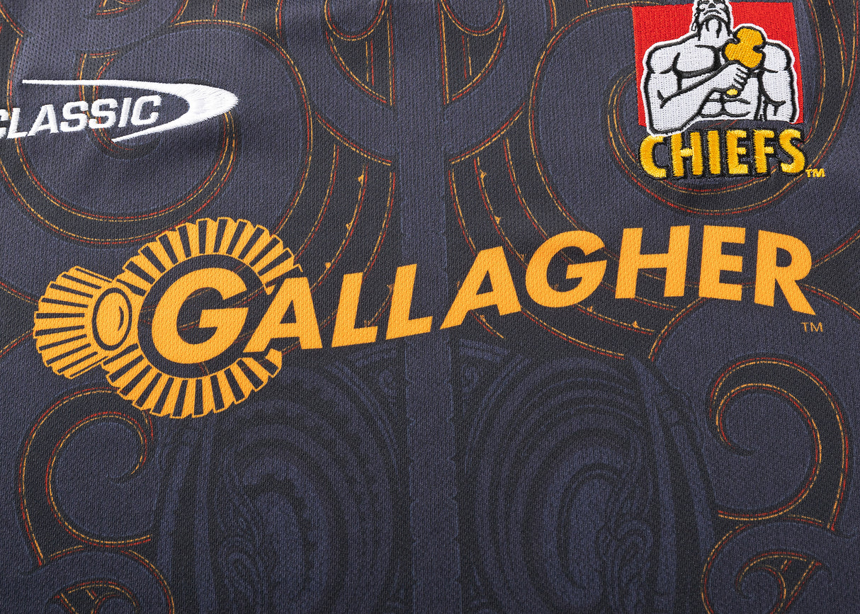 Close-up of a Gallagher Chiefs Super Rugby Replica Home Jersey 25/26 by Classic Sportswear with "Gallagher" and "Chiefs" logos. This stylish jersey embodies the team's spirit, making it ideal for any fan.