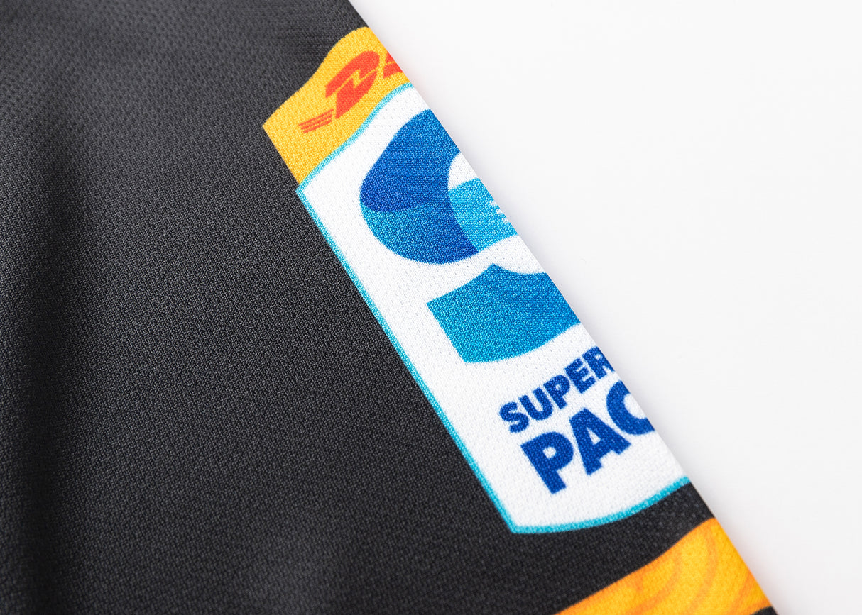 A close-up of the Classic Sportswear Gallagher Chiefs Super Rugby Replica Home Jersey 25/26 displaying DHL and Super Rugby Pacific logos on black fabric with traditional Māori patterns.