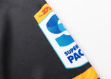 A close-up of the Classic Sportswear Gallagher Chiefs Super Rugby Replica Home Jersey 25/26 displaying DHL and Super Rugby Pacific logos on black fabric with traditional Māori patterns.