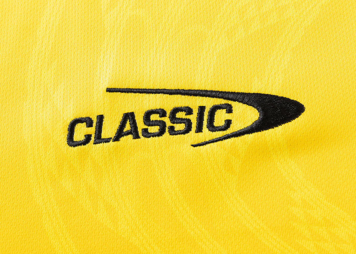 The Hurricanes Super Rugby 25/26 Replica Home Jersey by Classic Sportswear showcases elegant black "CLASSIC" embroidery and a curved design on yellow fabric, echoing the iconic style.