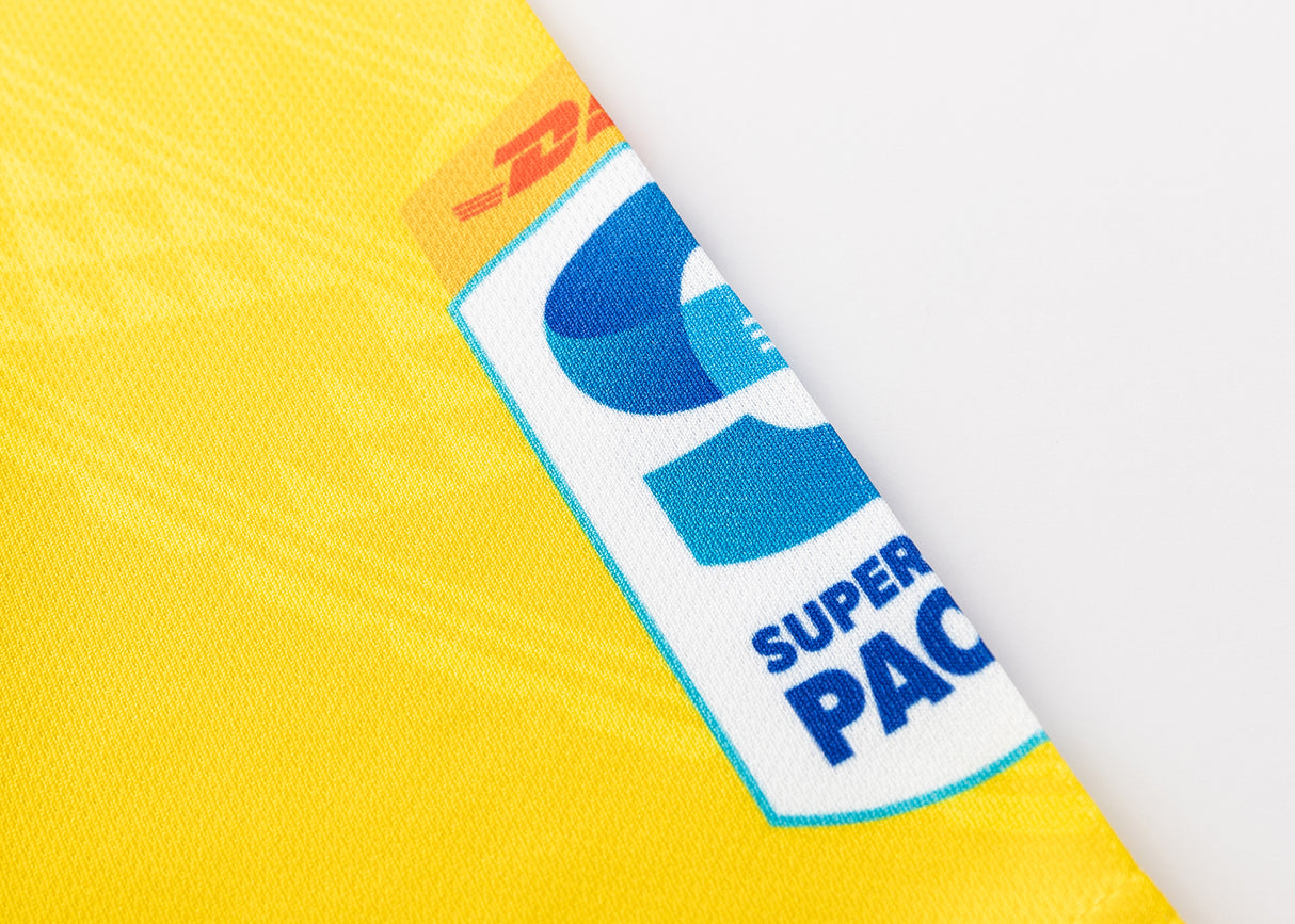 Close-up of a yellow DHL package with a prominent blue "Super Pacific" logo, indicating the exclusive delivery of a Hurricanes Super Rugby 25/26 Replica Home Jersey by Classic Sportswear.