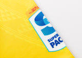 Close-up of a yellow DHL package with a prominent blue "Super Pacific" logo, indicating the exclusive delivery of a Hurricanes Super Rugby 25/26 Replica Home Jersey by Classic Sportswear.