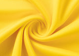 Close-up of yellow fabric spiraled, resembling the Hurricanes Super Rugby 25/26 Replica Home Jersey by Classic Sportswear, highlighting its texture and vibrant color.