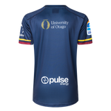 The Highlanders Super Rugby 25/26 Replica Home Jersey by Classic Sportswear features "University of Otago" and "Pulse Energy" logos on the back. Its blue, moisture-wicking fabric ensures comfort for fans cheering in the stands or on the go.