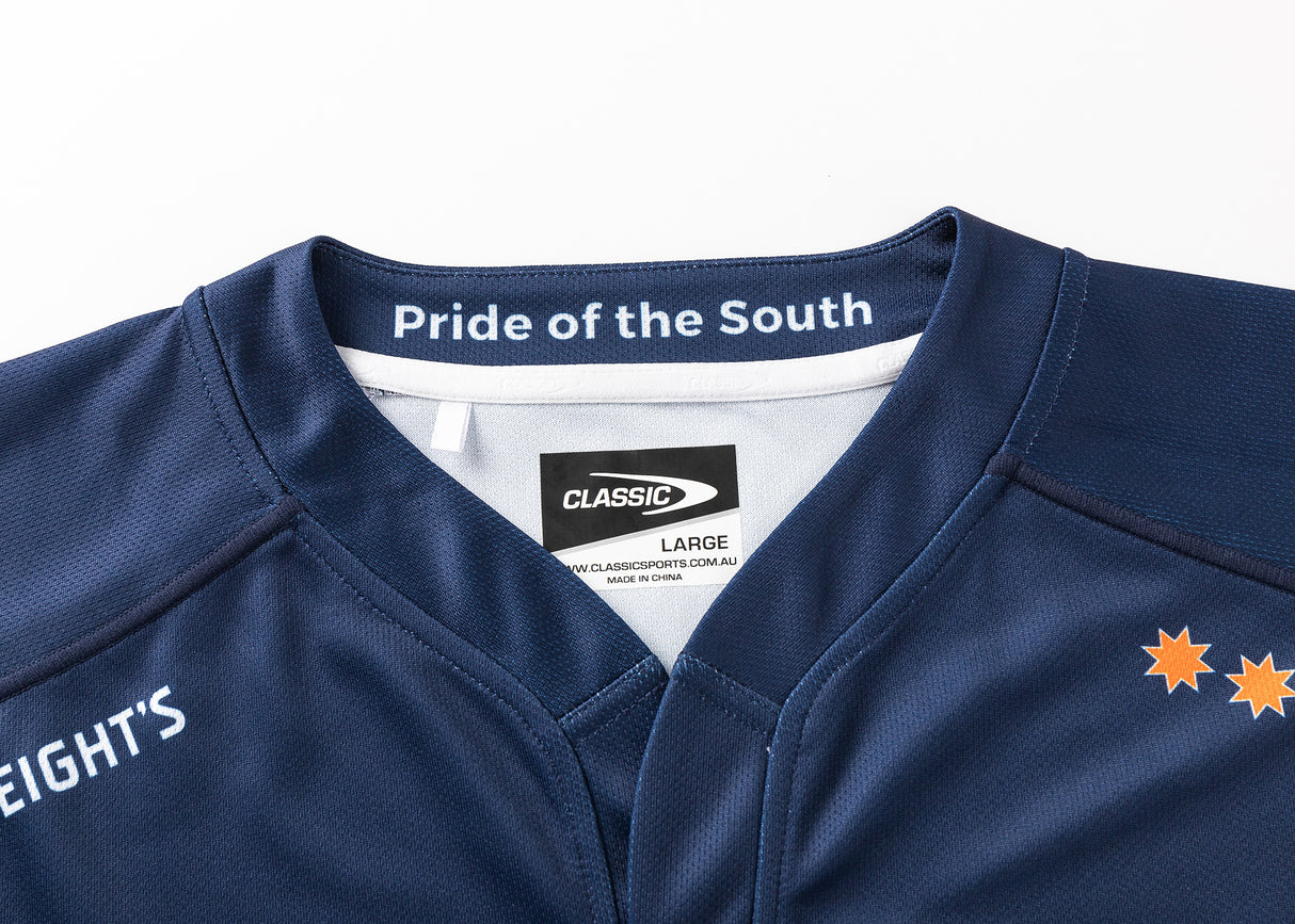 The Highlanders Super Rugby 25/26 Replica Home Jersey by Classic Sportswear boasts moisture-wicking fabric and features orange stars on the right shoulder. A navy blue hue with "Pride of the South" on the collar and a "CLASSIC" label assure authenticity, complemented by bold white side text.