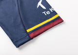 Close-up of the navy blue Highlanders Super Rugby 25/26 Replica Home Jersey by Classic Sportswear with yellow and red stripes, showing partial text "Te K" and a white logo on the upper left. Features moisture-wicking fabric for top comfort.