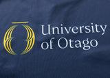 The Highlanders Super Rugby 25/26 Replica Home Jersey by Classic Sportswear features "University of Otago" text and a stylized yellow logo on a dark blue, moisture-wicking fabric.