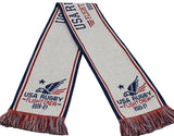 White knit USA Rugby Flight Crew 2026-27 Supporter’s Kit scarf with red and blue stripes, an eagle emblem, “2026-27” text, and fringed ends in red, white, and blue.