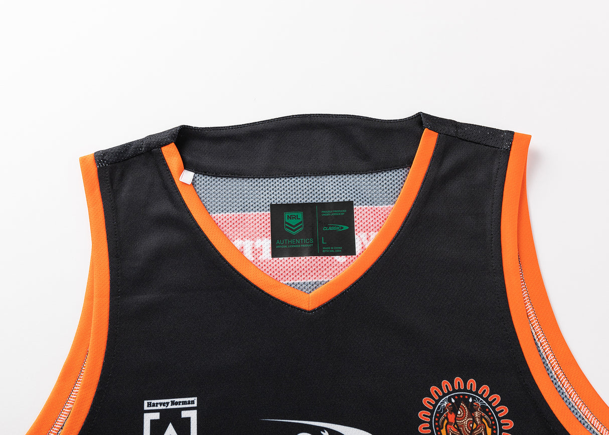The NRL Indigenous All Stars 25/26 Pro Training Singlet by Classic Sportswear is black with orange trim, featuring diverse logos and a stylized tiger head, capturing the team's spirit.