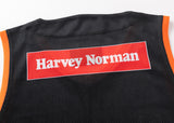 The NRL Indigenous All Stars 25/26 Pro Training Singlet by Classic Sportswear is a black mesh jersey with orange trim, featuring a "Harvey Norman" logo on a red and white patch, combining style and performance for fans.