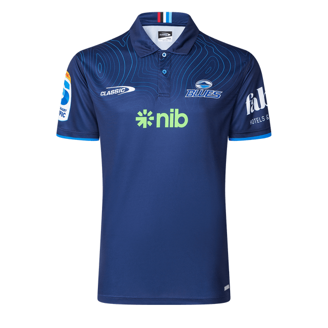 The Blues Super Rugby 25/26 Team Polo by Classic Sportswear is a blue jersey featuring short sleeves, a subtle circular pattern, and logos including "nib" and "Blues," perfect for any Blues fan.