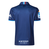 The back of the Blues Super Rugby 25/26 Team Polo by Classic Sportswear features a wavy line pattern and white text reading "WE ARE THE BLUES," celebrating classic sportswear.