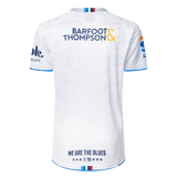 Back view of the Blues Super Rugby 25/26 Replica Away Jersey by Classic Sportswear in white, featuring "Barfoot & Thompson" and "WE ARE THE BLUES" text, with blue and orange accents on sleeves and collar.