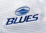 The Blues Super Rugby 25/26 Replica Away Jersey by Classic Sportswear features white fabric with "BLUES" embroidered in blue beneath a circular mountain and waves logo, designed for fans.