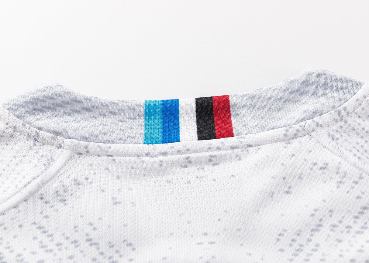 A close-up of the Blues Super Rugby 25/26 Replica Away Jersey by Classic Sportswear shows a classic sportswear neckline with blue, black, and red stripes on the collar. The fabric has a subtle gray speckled pattern, ideal for Blues Super Rugby fans.