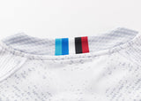 A close-up of the Blues Super Rugby 25/26 Replica Away Jersey by Classic Sportswear shows a classic sportswear neckline with blue, black, and red stripes on the collar. The fabric has a subtle gray speckled pattern, ideal for Blues Super Rugby fans.