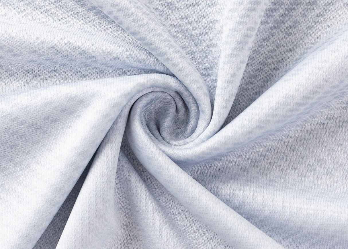 Close-up of the Blues Super Rugby 25/26 Replica Away Jersey by Classic Sportswear, featuring light grey fabric with a subtle dotted pattern swirled at the center—echoing an iconic sportswear design.