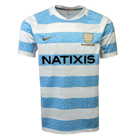The Racing 92 Replica Home Jersey by Nike is a light blue and white striped sports jersey that proudly features the "Racing 92" and "Natixis" logos.