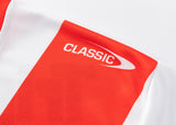 Detailed view of a red and white striped fabric with "CLASSIC" on the red stripe, epitomizing the Dragons NRL 25/26 Replica Home Jersey by Classic Sportswear.