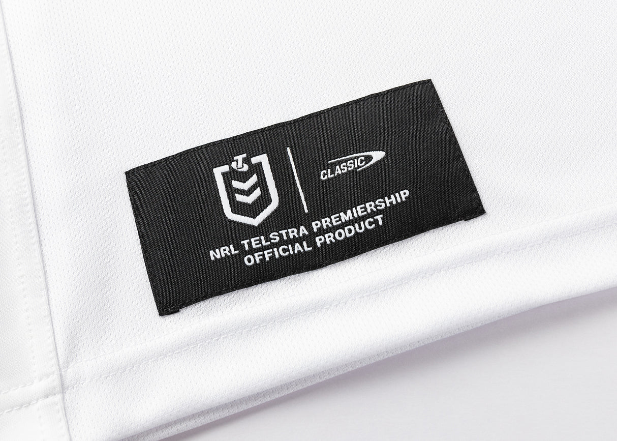 A white fabric label with a black patch and white text reads "NRL Telstra Premiership Official Product" beside the Classic logo, identifying the Dragons NRL 25/26 Replica Home Jersey by Classic Sportswear.