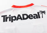 The Dragons NRL 25/26 Replica Home Jersey by Classic Sportswear features "TripADeal" in bold black text with a palm tree graphic on the back. Ideal for Dragons fans wanting to show team spirit.