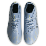 Top view of IDA Sports' IDA Helia Club FG women's soccer cleats in light blue with yellow accents and black detailing, laces, and brand label on the tongue—ideal firm ground boots.