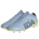 The IDA Helia Club FG by IDA Sports is a pair of light blue women's soccer cleats with yellow accents, bold black branding on the side, and yellow studs—perfect firm ground boots for style and performance.