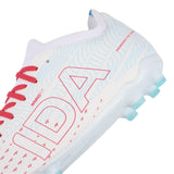 Close-up of the IDA Helia Club FG/AG women’s soccer cleats by IDA Sports in white with red laces, light blue patterns, and the red “IDA” logo on the side. The sole features light blue studs designed for firm ground and artificial grass play, with “ENGINEERED FOR WOMEN” printed near the heel—an ideal choice for beginner players.