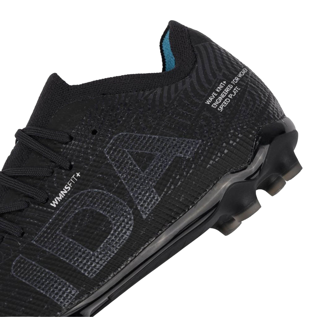 Close-up of the IDA Helia Elite FG/AG by IDA Sports—a women-specific black and dark grey soccer cleat featuring a textured upper, visible laces, “WINSETT+” text, and part of the sole with “ENGINEERED FOR SPEED PLATE” near the heel—crafted for peak performance.