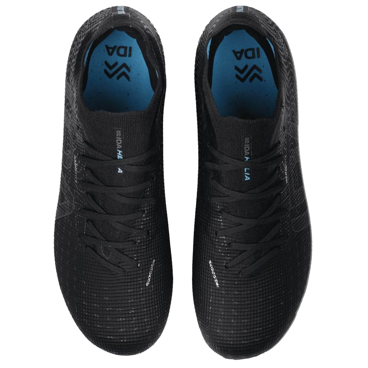 Top view of a pair of black IDA Helia Elite FG/AG athletic shoes with blue insoles, featuring the brand name “IDA Sports” and a textured mesh design. These shoes showcase a women-specific design inspired by elite soccer cleats, combining performance-focused features with stylish details.