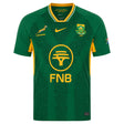 Introducing the Springboks 26/27 Greatest Rivalry Replica Home Jersey by Nike. This authentic replica rugby jersey features iconic green with yellow accents, sponsor logos, the Springboks emblem, and a subtle printed text pattern. Complete with the South African flag on the sleeve, it’s the perfect choice for dedicated fans of Nike and South Africa rugby.