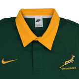 The Springboks 26/27 Classic Long Sleeve Home Jersey by Nike features a green design with a yellow collar, yellow Nike logo, and Springboks emblem on the chest, plus an authentic Nike rugby shirt tag inside the collar.