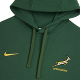 The Springboks 26/27 Pullover Hoodie by Nike is a green pullover with a yellow Nike logo, the South Africa rugby team’s Springboks logo, and "SPRINGBOKS" text below.