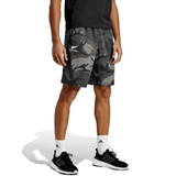 A person wearing a black shirt, adidas All Blacks Camo Shorts, white socks, and black sneakers stands against a white background.