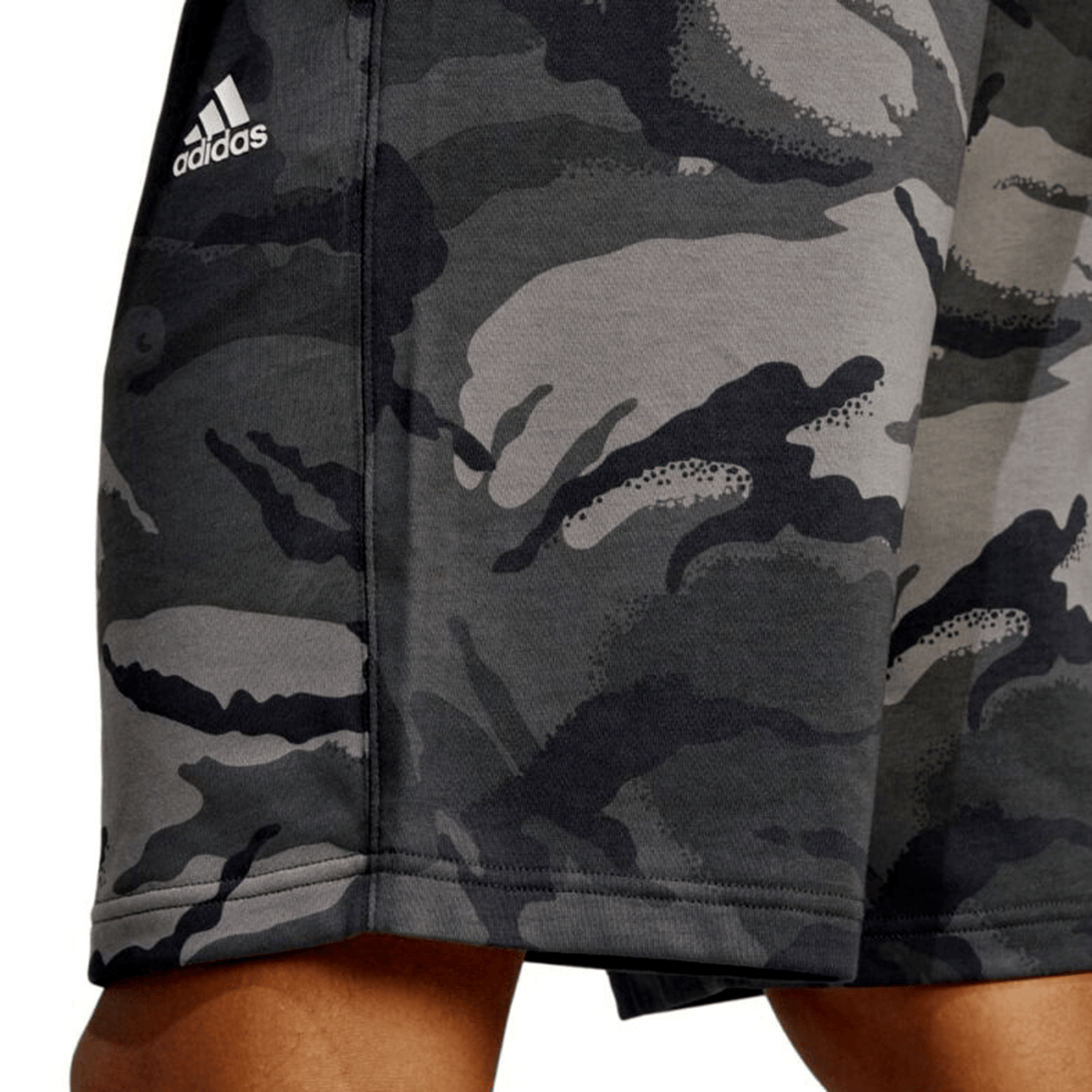 Person wearing All Blacks Camo Shorts by adidas, embodying the fierce spirit of the All Blacks with its grey camouflage print.
