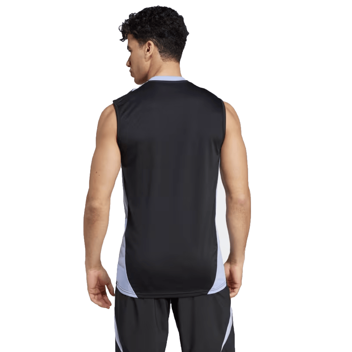 A man stands with his back to the camera, wearing the All Blacks 24/25 Performance Singlet by Adidas, a sleeveless athletic shirt in black and white.