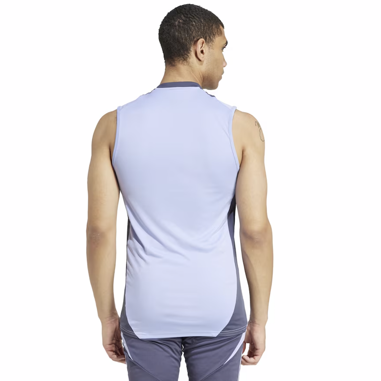 A man stands facing away, wearing an adidas All Blacks 24/25 Performance Training Singlet with AEROREADY Technology and dark shorts against a plain white background.