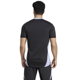 A person with short curly hair, dressed in a black and gray All Blacks 24/25 Performance T-Shirt by adidas, is seen from the back.