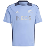 The light blue All Blacks 24/25 Performance T-Shirt by adidas showcases the "INEOS" logo, New Zealand All Blacks emblem, and incorporates AEROREADY technology for optimal comfort both on and off the field.