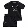The adidas Infant All Blacks 24/25 Home Kit includes a V-neck jersey and shorts with silver accents, featuring AEROREADY Technology for comfort.