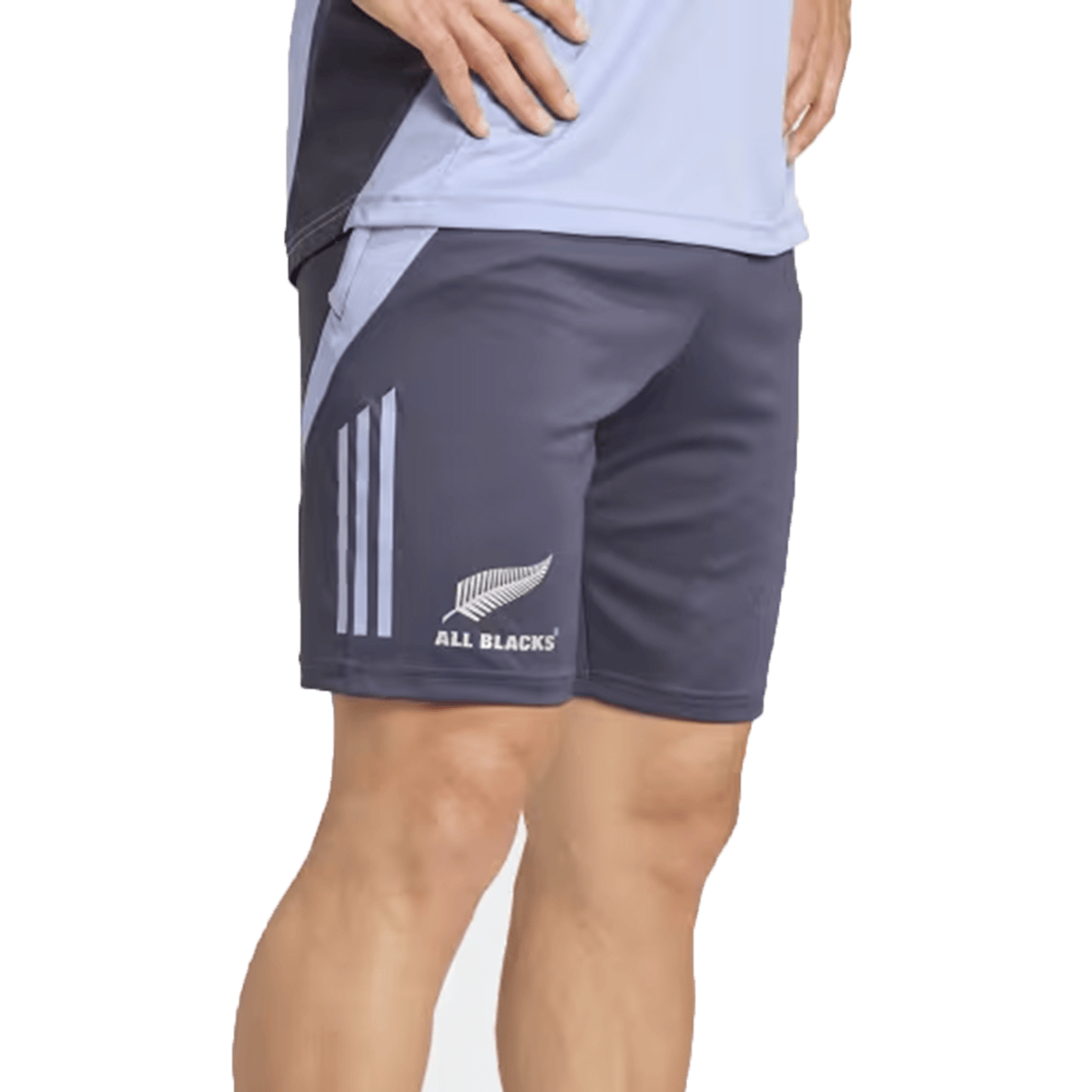 A person dressed in the All Blacks 24/25 Performance Gym Shorts by Adidas, showcasing the iconic "All Blacks" logo and fern design, elegantly crafted from recycled materials.