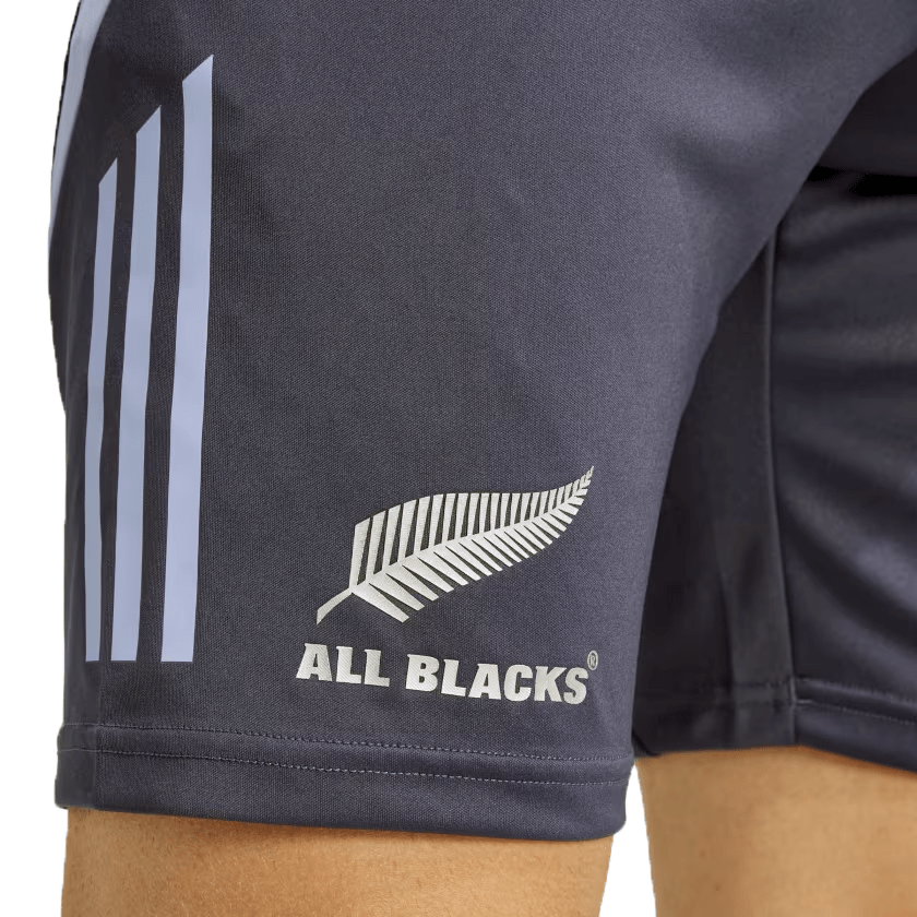 A close-up shot of someone wearing the All Blacks 24/25 Performance Gym Shorts by adidas, showcasing the three stripes on the side and eco-friendly materials used in their design.