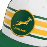 A close-up of a white and green Nike Springboks Trucker Heritage Rugby Cap featuring the embroidered Springboks logo.