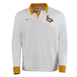 The Springboks Heritage Long Sleeve Rugby Jersey by Nike - HO25 is a white jersey with gold collar and cuffs, featuring the Nike logo and the iconic Springboks emblem on the chest.