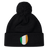 The EMB Canterbury Ireland Shield Pom Pom Beanie features a stylish shield emblem with green, white, and orange vertical stripes, reminiscent of the Ireland flag.