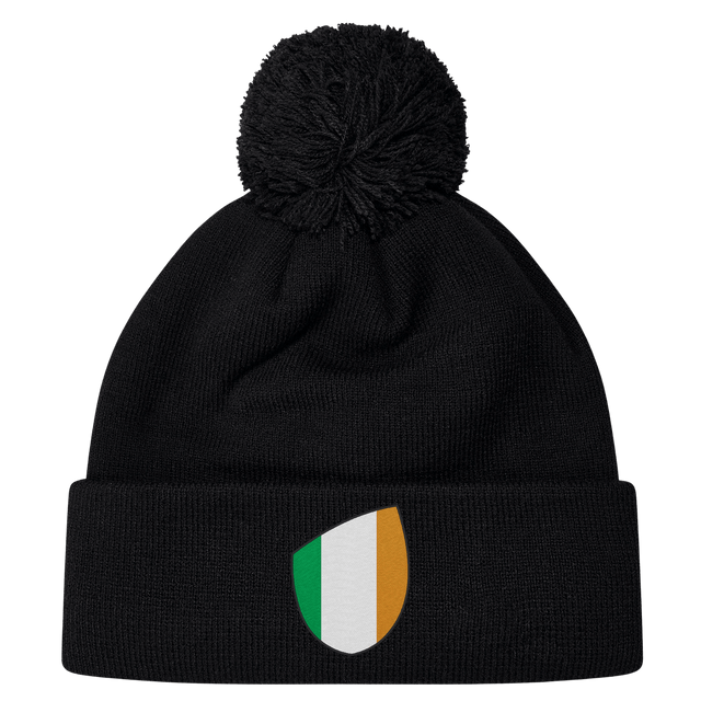 The EMB Canterbury Ireland Shield Pom Pom Beanie features a stylish shield emblem with green, white, and orange vertical stripes, reminiscent of the Ireland flag.